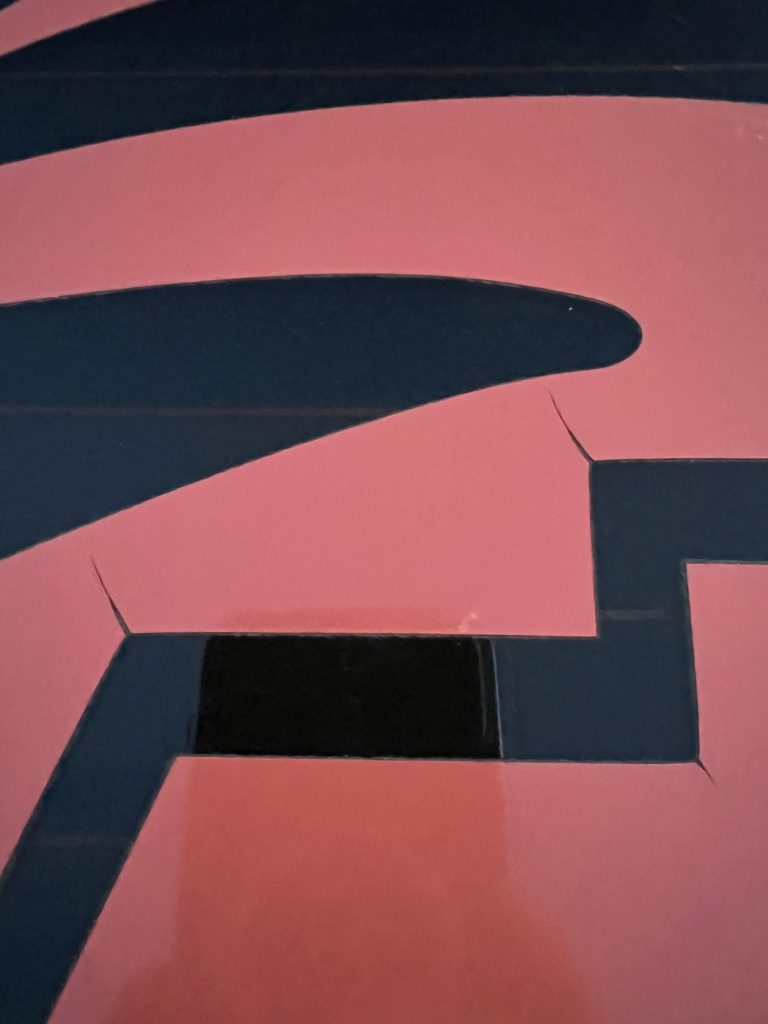 Calendered vinyl on a vehicle windshield that is cracking and peeling
