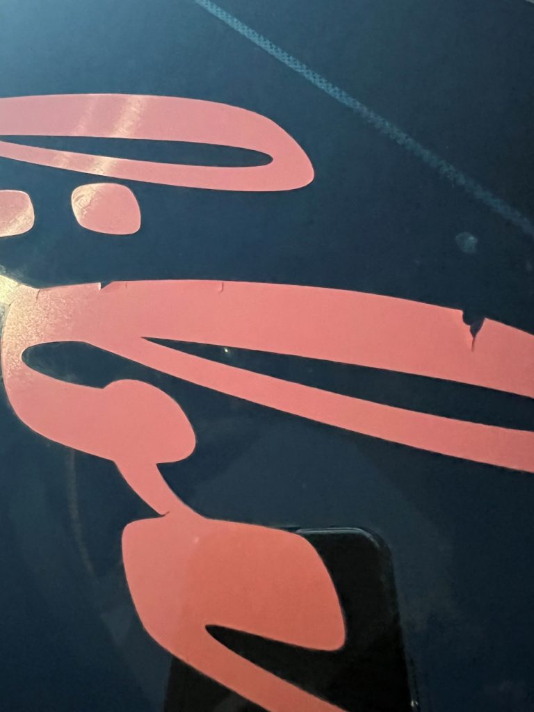 Calendered vinyl cracking and peeling on a vehicle graphic